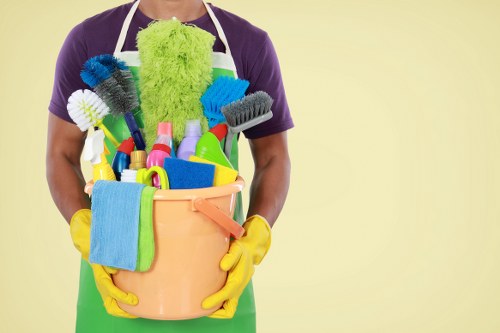 Office cleaners sanitising desks and shared surfaces in Chelsea