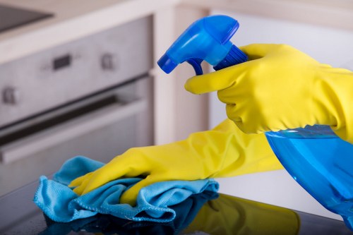 Cleaner using safe manual handling practices with equipment