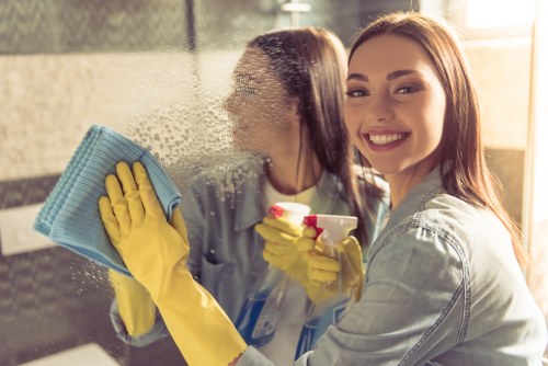 Technician performing oven cleaning in a Chelsea kitchen